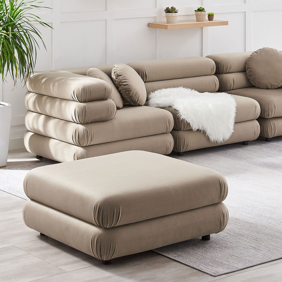 Taupe velvet ottoman styled with matching modular seating to create a cozy, layered lounge look || EEI-6899-TAU || front_angle_room