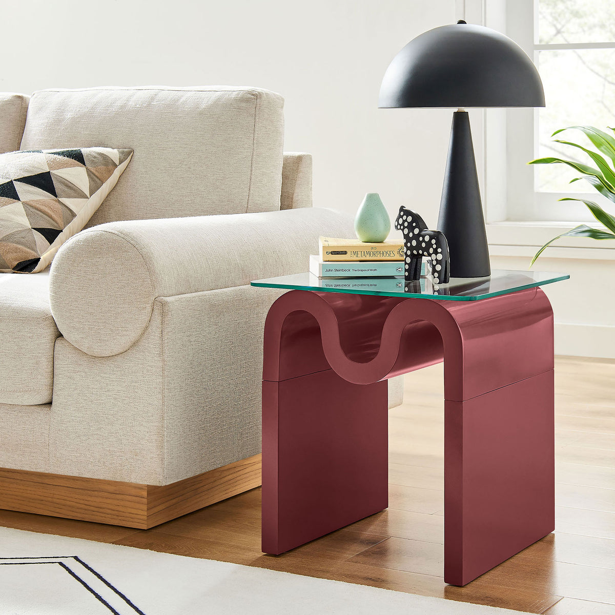 Ondine spiced apple glass top side table next to a sofa, adding a playful modern accent to the living room || EEI-6902-SPA || front_angle_room