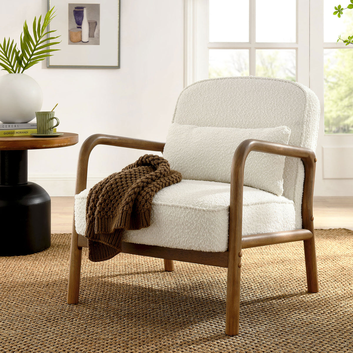 Inviting ivory boucle armchair with curved wooden arms and matching pillow warms the space || EEI-6909-IVO || front_angle_room