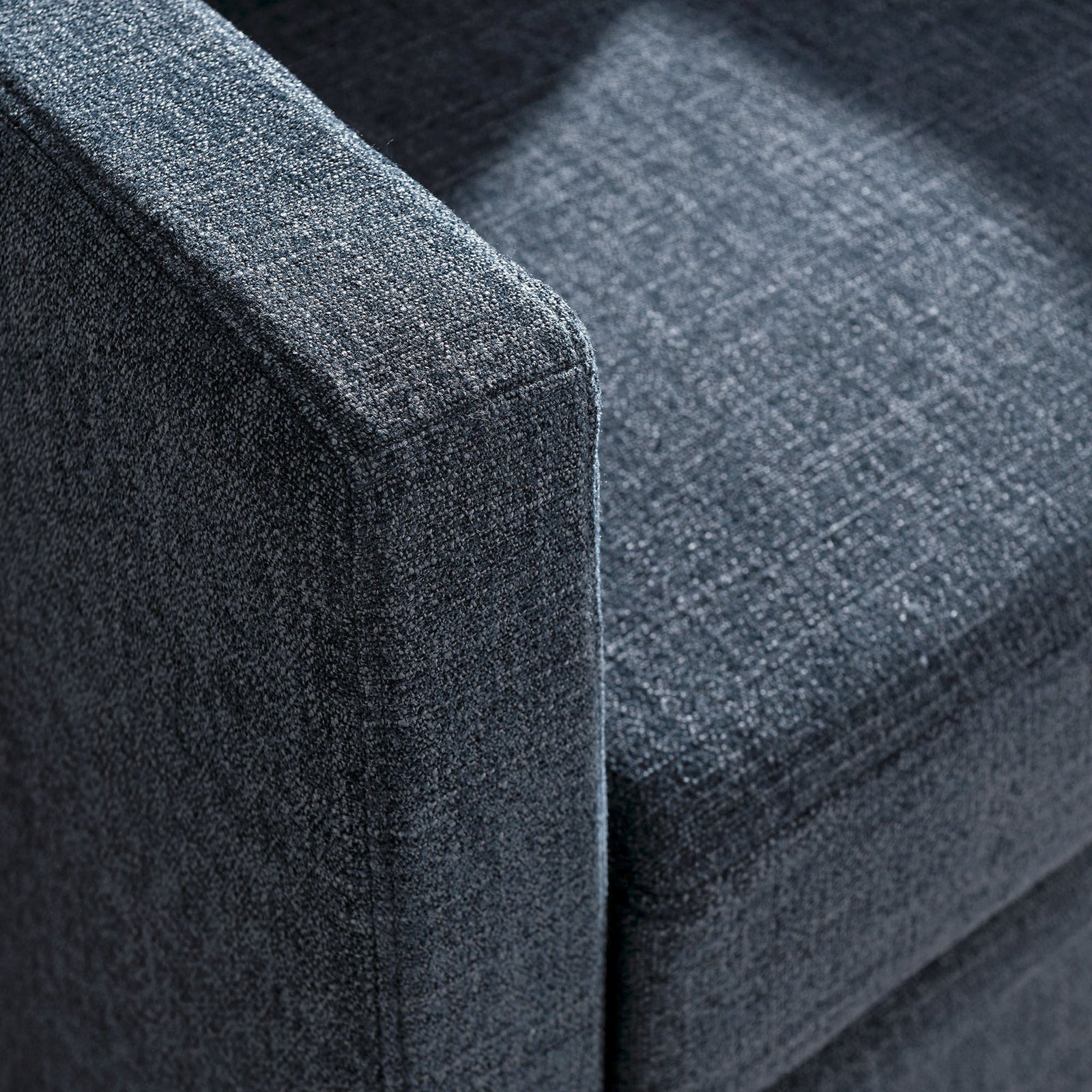 Crisp corner seams and textured fabric highlight the chair's refined, durable tailoring || EEI-6910-SLB || detail_studio