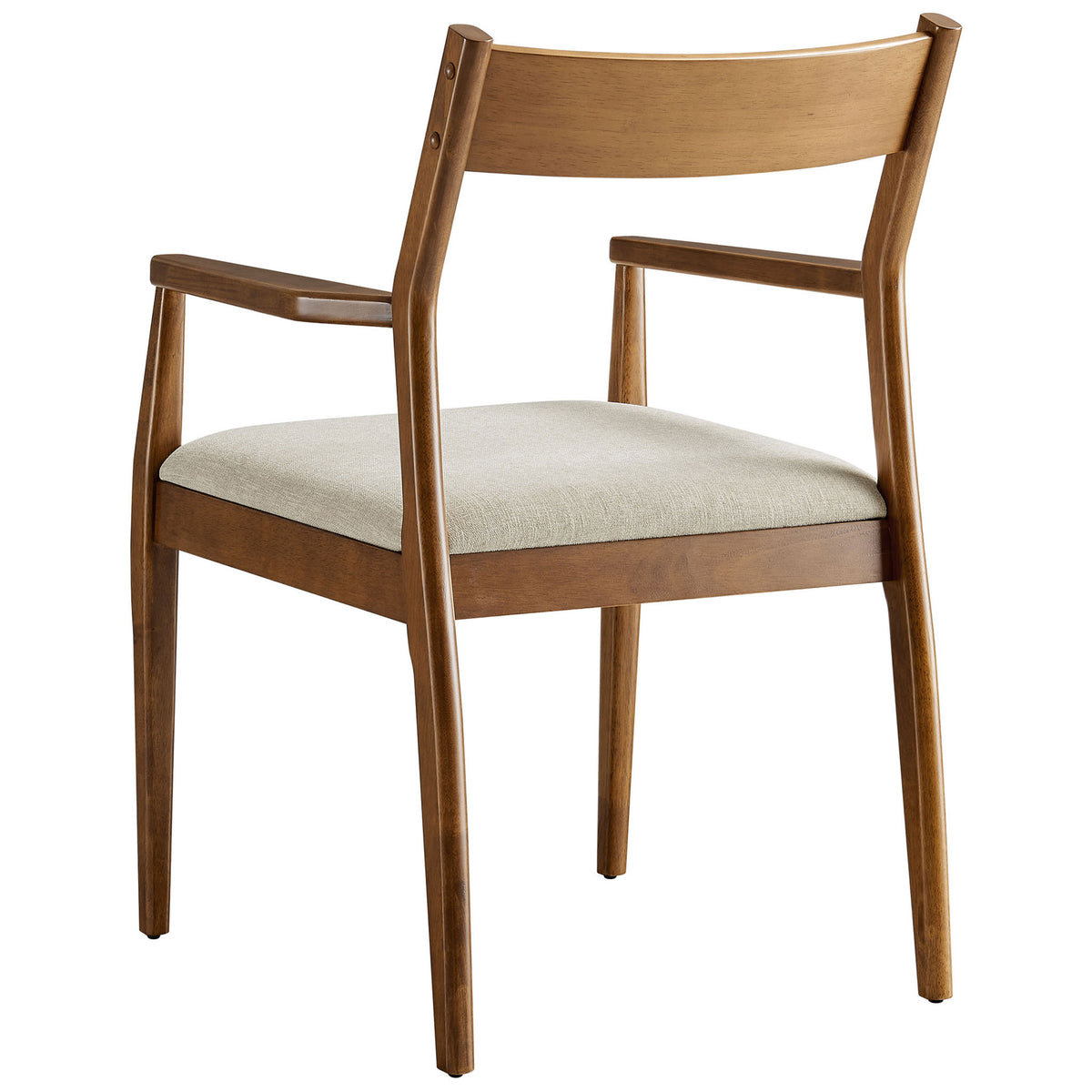 Walnut wood dining chair emphasizing the smooth curved back rail and supportive frame above the beige cushion || EEI-6916-WAL-HEB || back_angle_studio