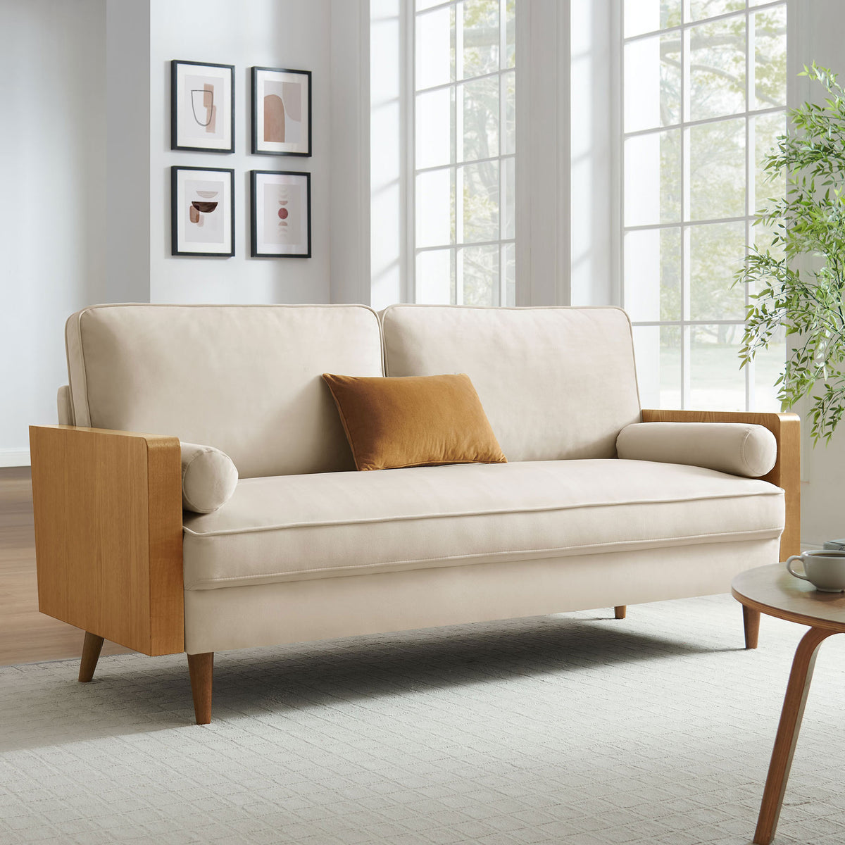 Cream velvet sofa with walnut arms styled in a bright living room with modern art and greenery || EEI-6944-WAL-ALA || front_angle_room
