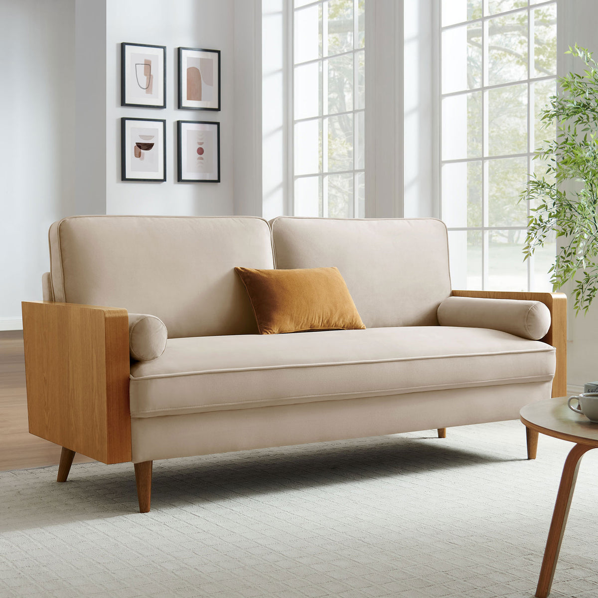 Kellan performance velvet sofa in a bright living room, paired with a neutral rug, modern art, and warm walnut accents || EEI-6944-WAL-ALM || front_angle_room