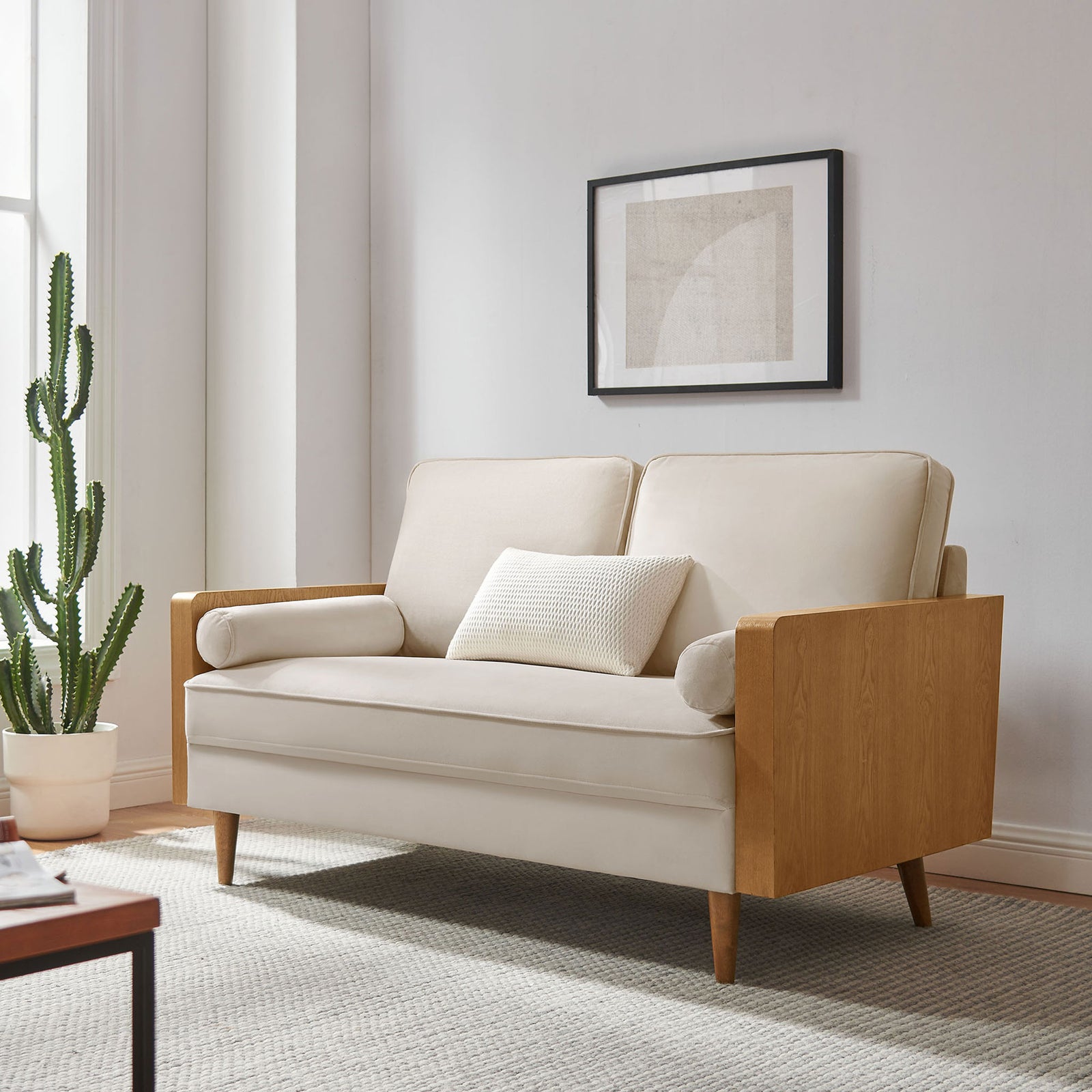 Cream velvet loveseat with wood arms styled in a bright modern living room || EEI-6945-WAL-ALM || front_angle_room