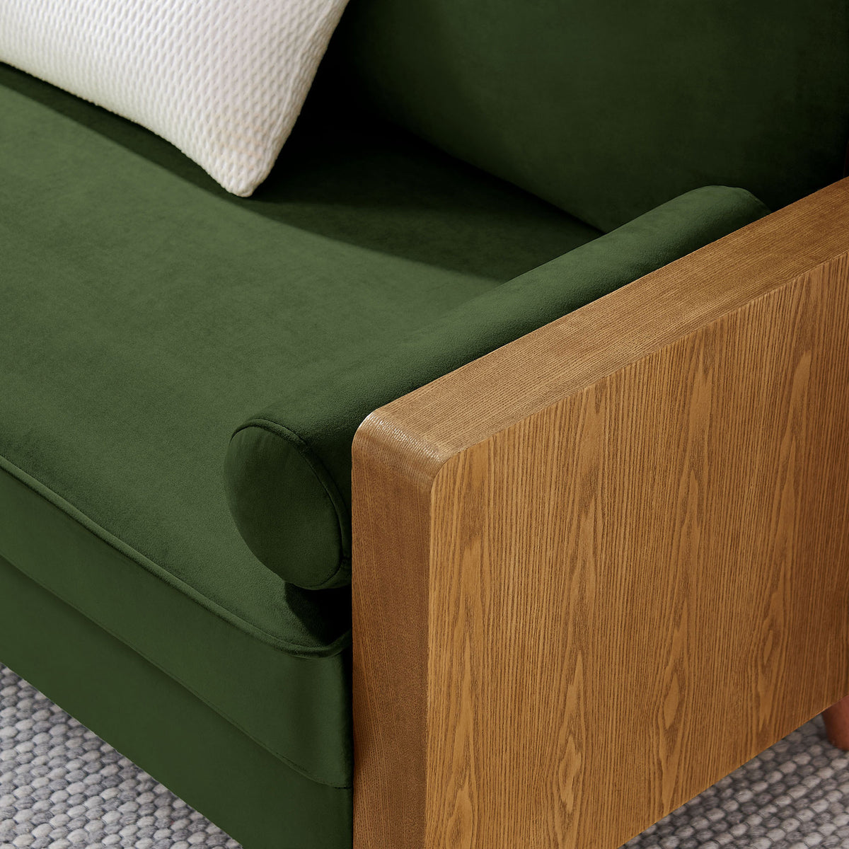 Moss green velvet loveseat arm styled with white accent pillow and textured area rug || EEI-6945-WAL-MOG || detail_room