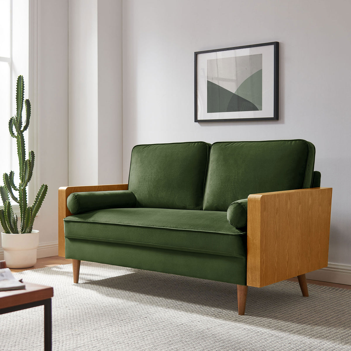 Moss green velvet loveseat in a modern living room with cactus plant and wall art || EEI-6945-WAL-MOG || front_angle_room