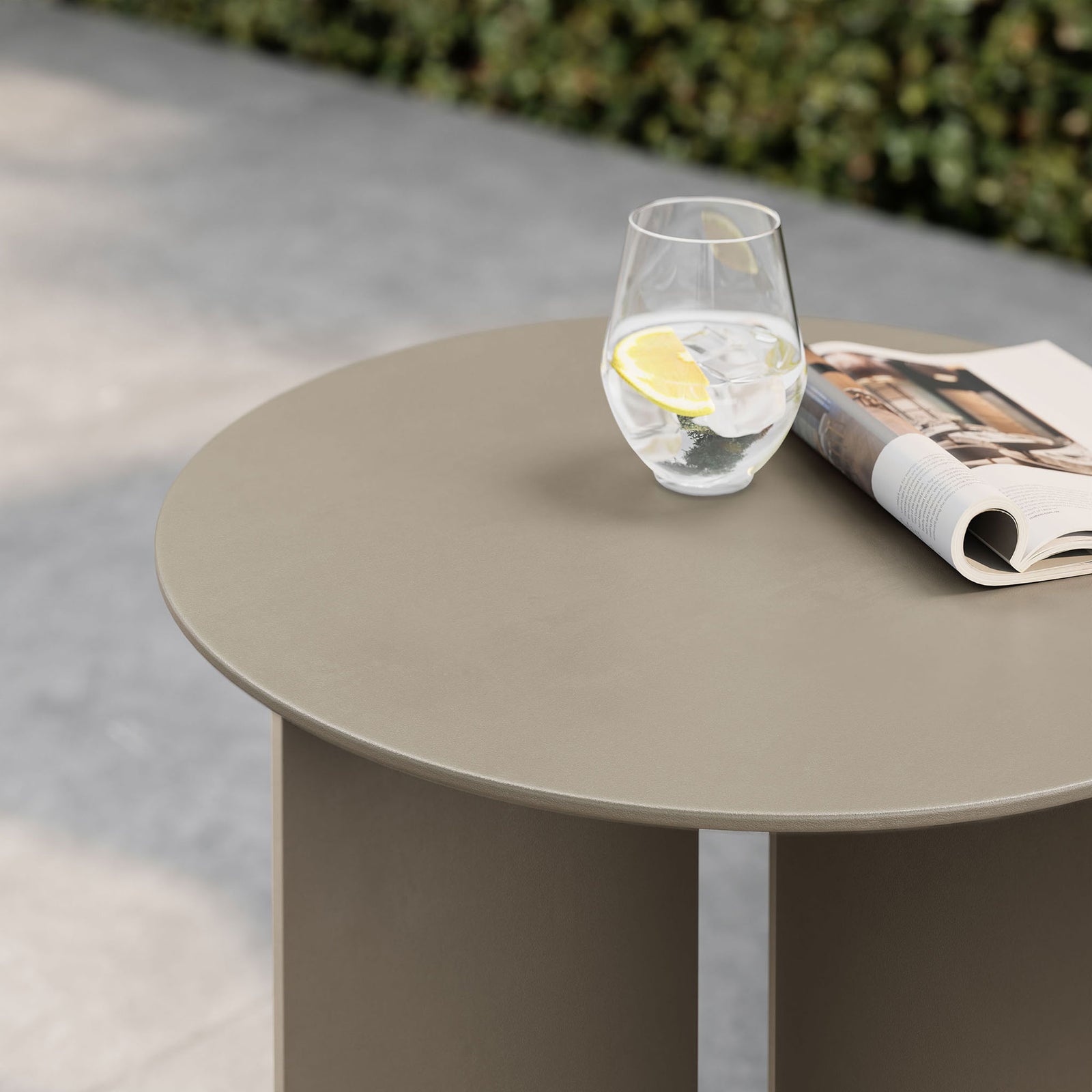 Khaki outdoor side table top styled with drink and magazine on sleek patio || EEI-6946-KHA || detail_room