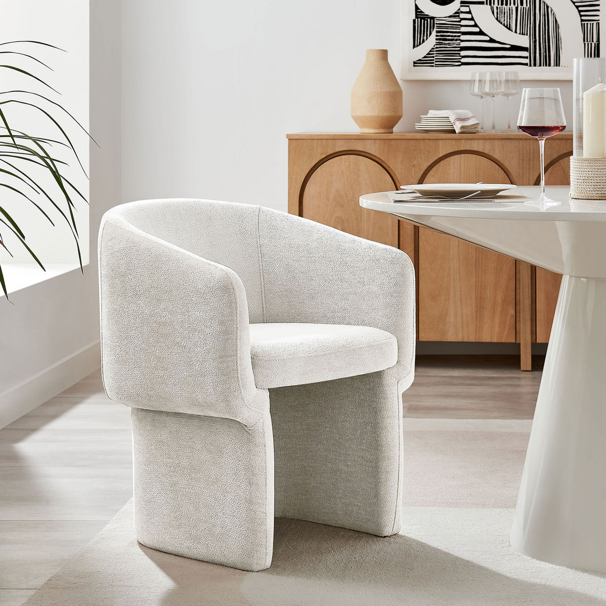 Ivory chenille barrel armchair tucked around a modern dining table, bringing cozy texture to a light wood setting || EEI-6951-IVO || front_angle_room
