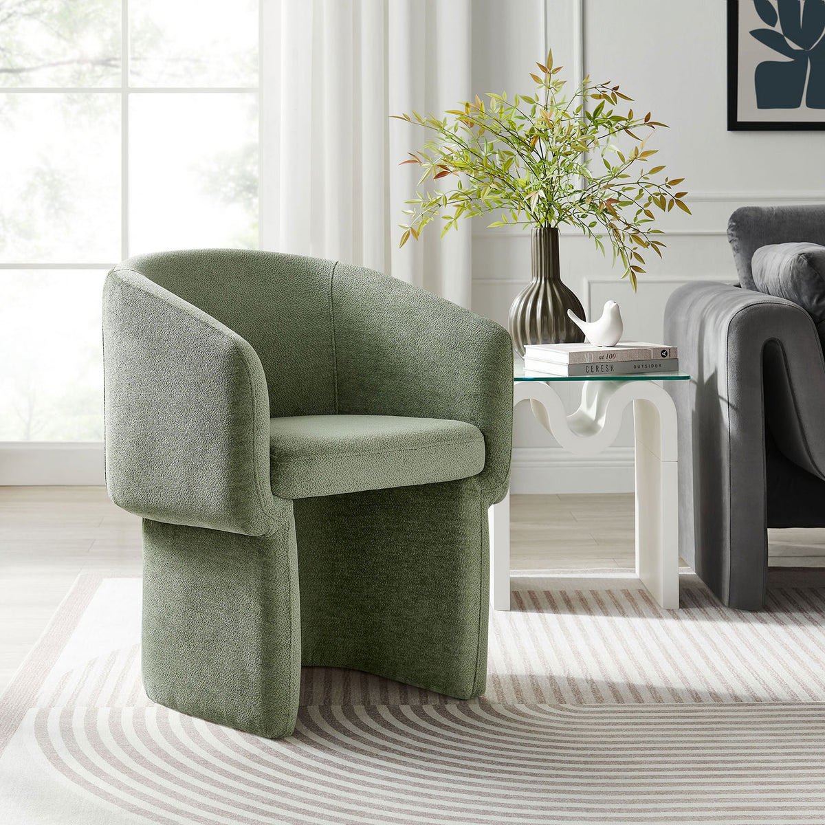 Sage green Verity barrel chair styled in a bright living room beside a sculptural white side table || EEI-6951-SGE || front_angle_room