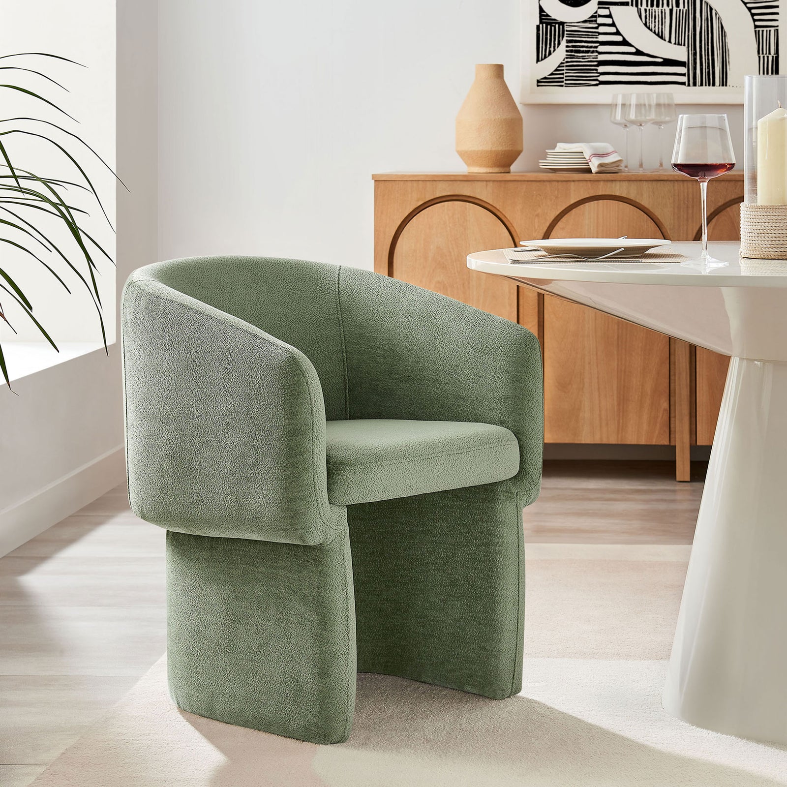 Verity sage chenille armchair paired with a modern dining table and warm wood buffet in a chic setting || EEI-6951-SGE || front_angle_room