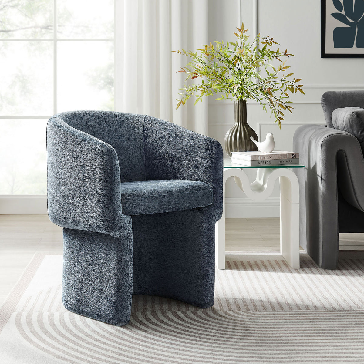Slate blue chenille barrel armchair styled as a cozy accent seat in a bright modern living room || EEI-6951-SLA || front_angle_room