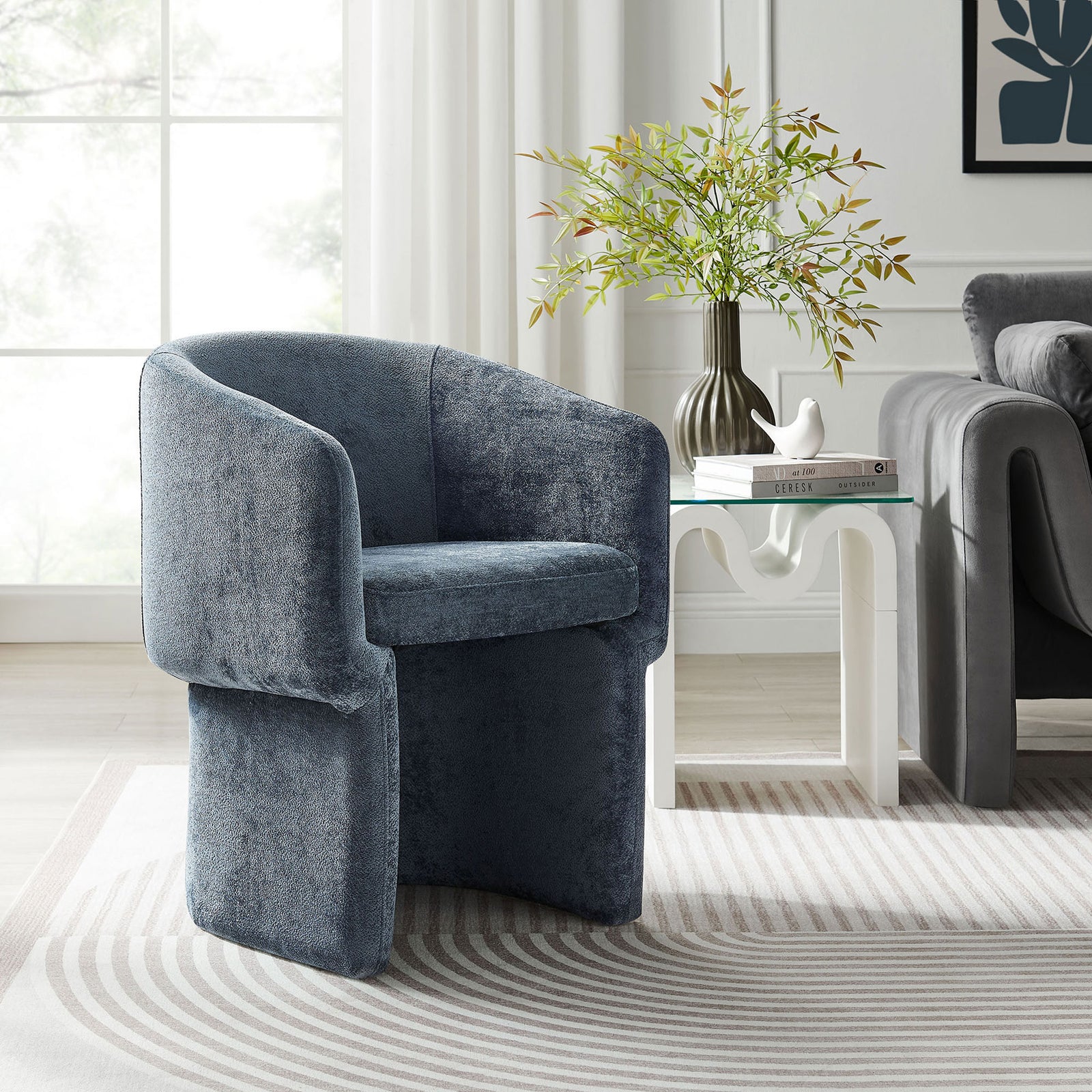 Slate blue chenille barrel armchair styled as a cozy accent seat in a bright modern living room || EEI-6951-SLA || front_angle_room