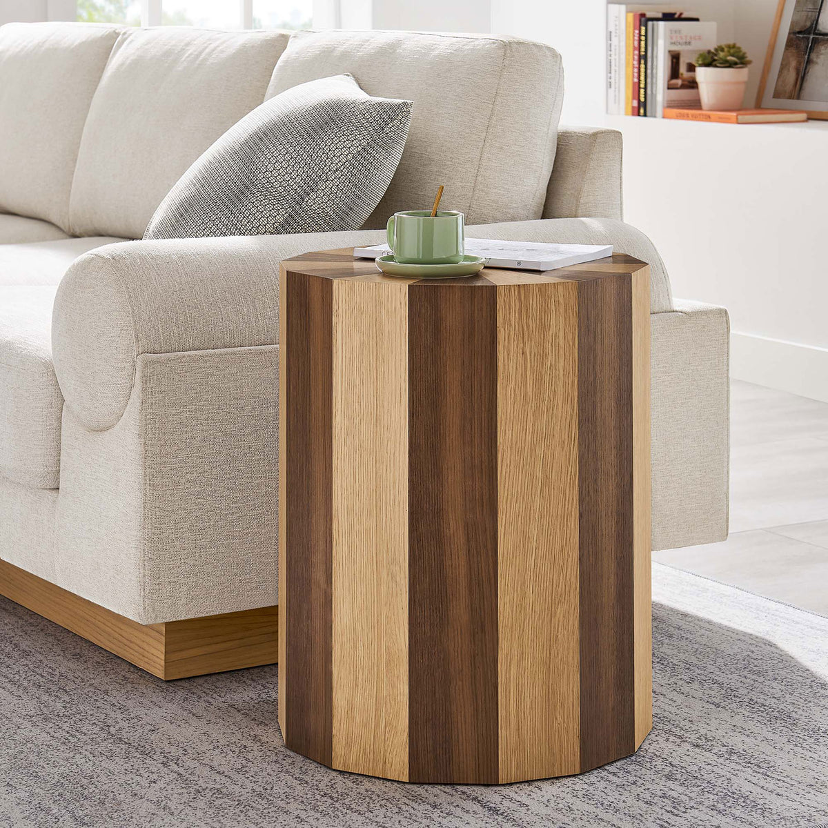 Twirl two-toned side table adding warm wood texture next to a modern sofa and area rug || EEI-6952-OAK-WAL || front_angle_room
