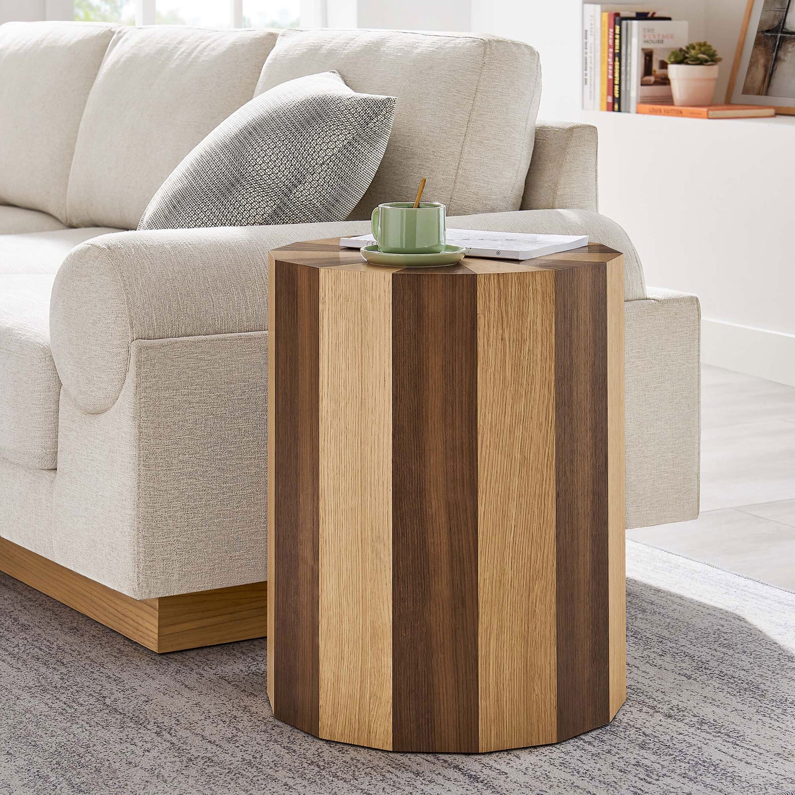 Twirl two-toned side table adding warm wood texture next to a modern sofa and area rug || EEI-6952-OAK-WAL || front_angle_room
