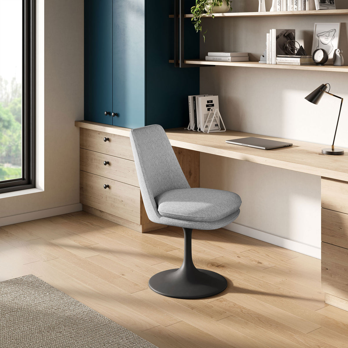 Gray swivel chair used as an armless desk seat beside a long wood workspace in a bright home office || EEI-6953-BLK-HLG || front_angle_room