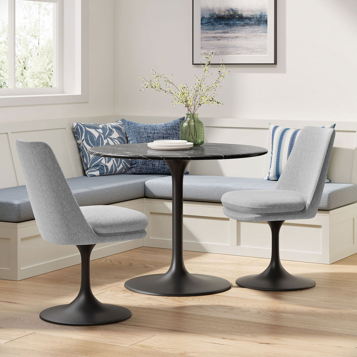 Pair of gray pedestal dining chairs surrounding a round black table in a light-filled breakfast nook || EEI-6953-BLK-HLG || front_angle_room