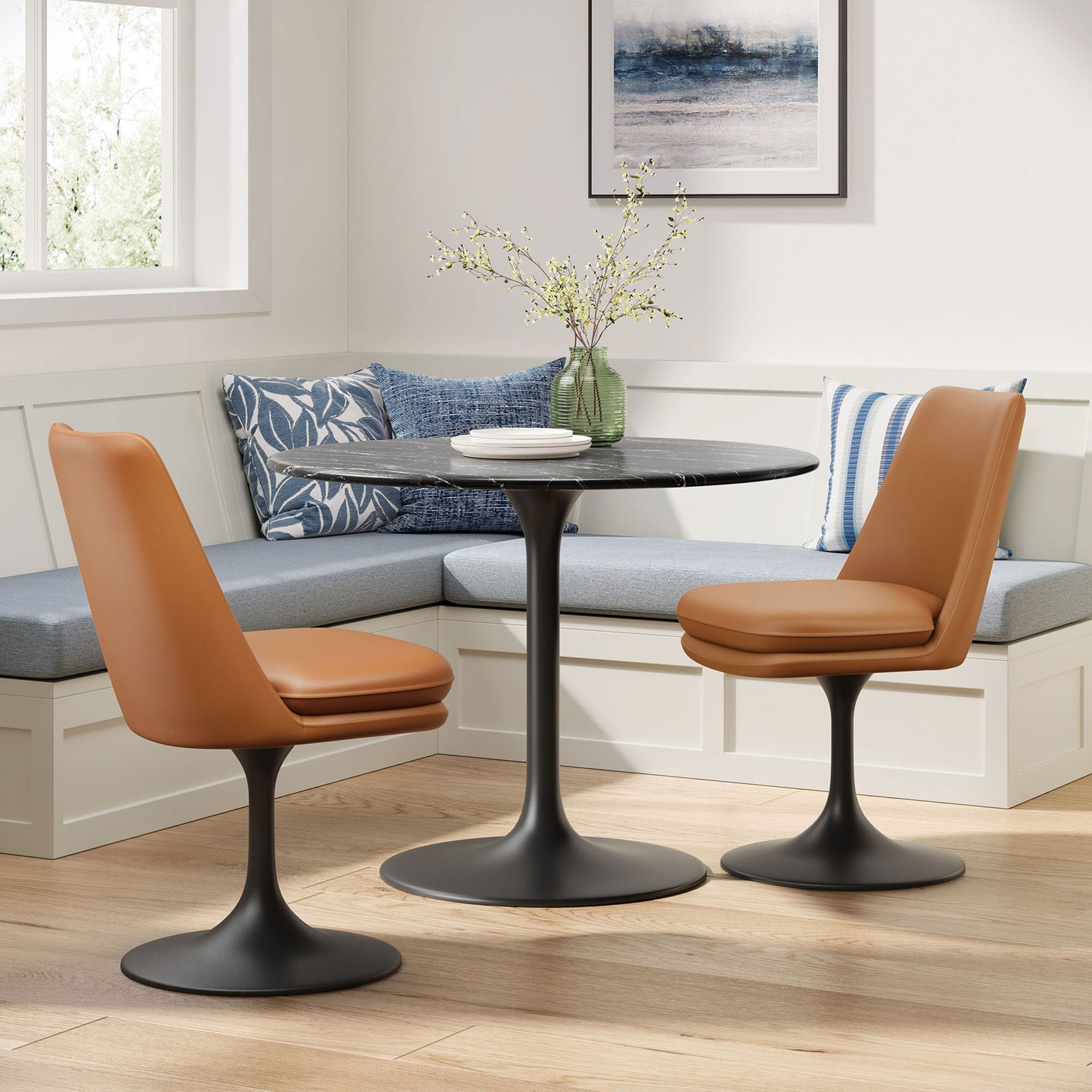 Pair of tan vegan leather Lippa swivel chairs around a round pedestal dining table in a bright breakfast nook || EEI-6955-BLK-TAN || front_angle_room