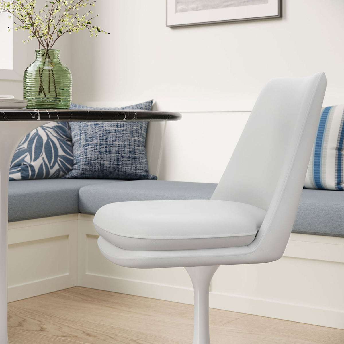 White vegan leather dining chair tucked at a cozy breakfast nook with upholstered bench and patterned pillows || EEI-6955-WHI-WHI || front_angle_room