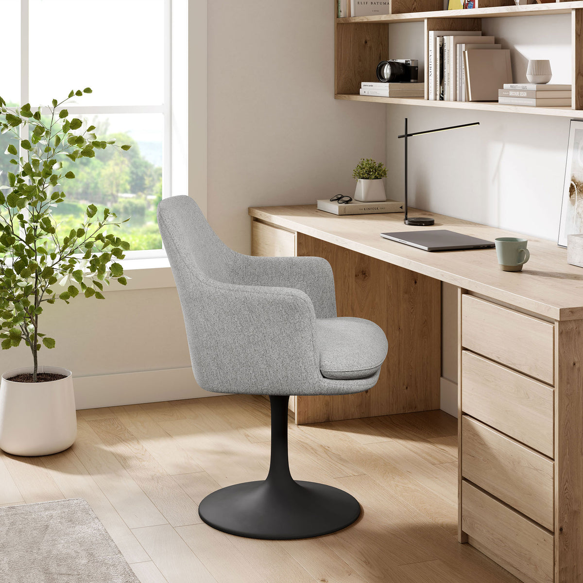Gray Lippa swivel armchair paired with a natural wood desk in a bright home office || EEI-6956-BLK-HLG || side_room