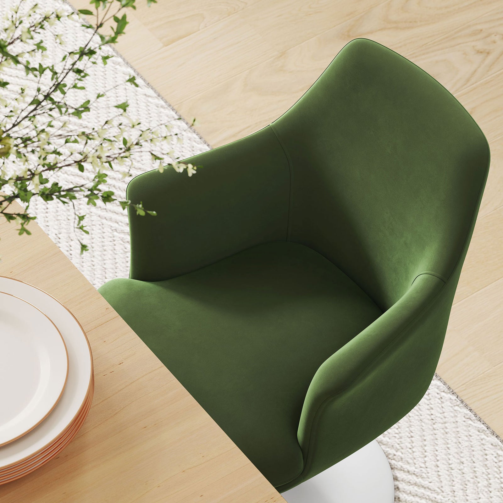 Green velvet dining armchair at a light wood table over a soft textured area rug || EEI-6957-WHI-MOG || top_angle_room