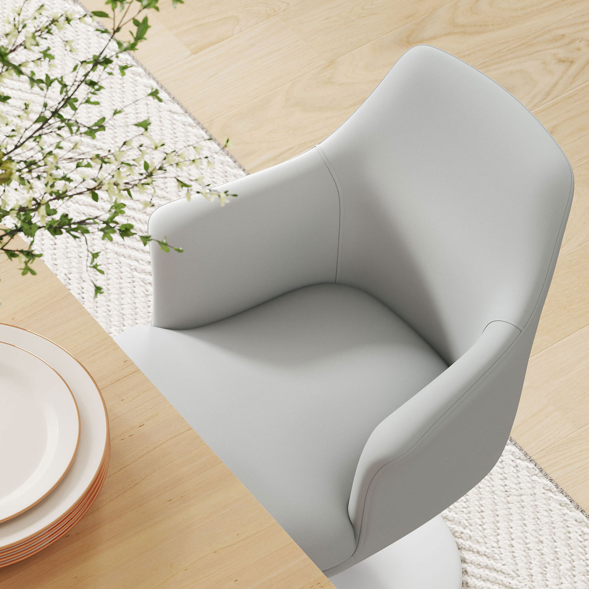 White vegan leather armchair at a light wood dining table showing contoured seat and supportive arms || EEI-6958-WHI-WHI || detail_room