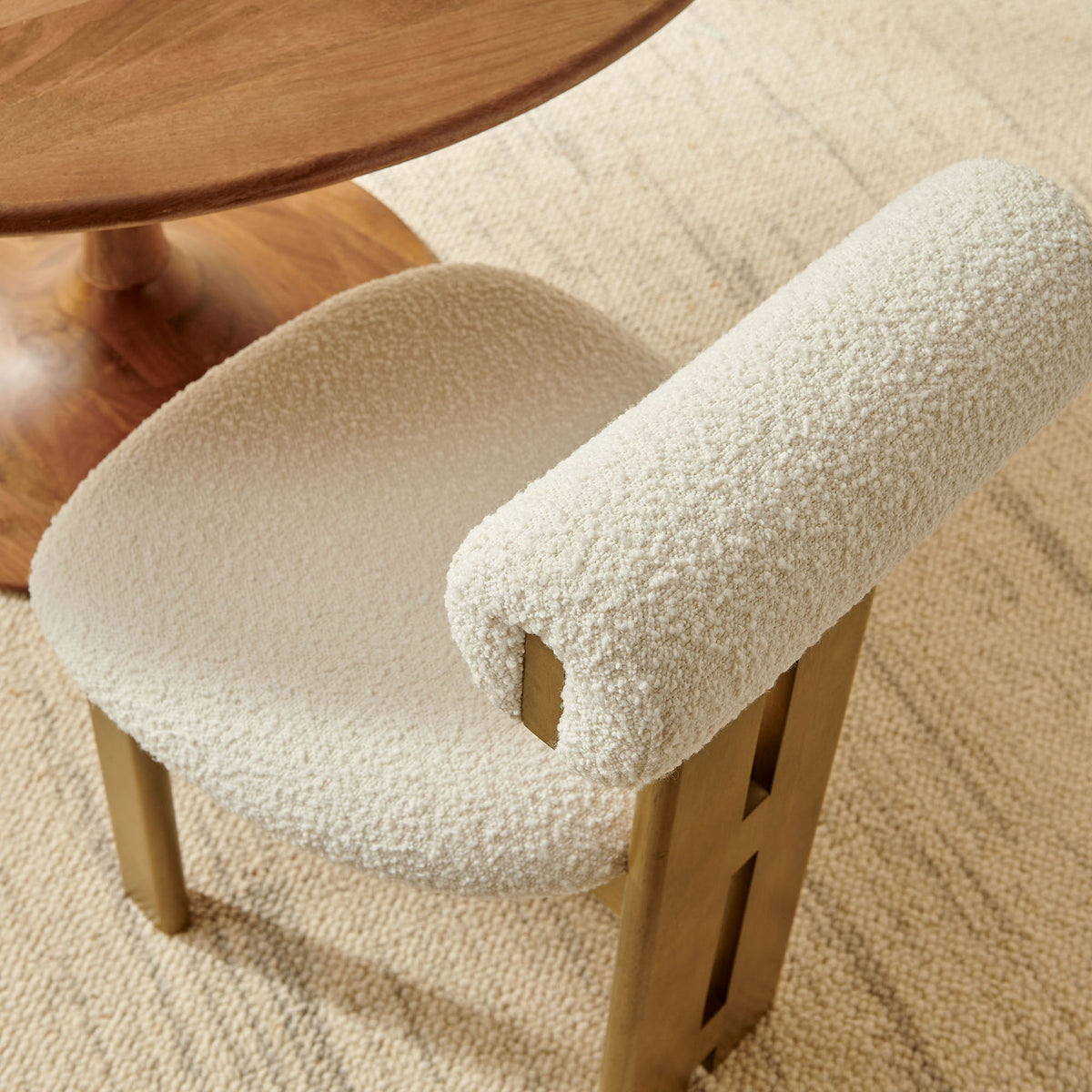 Ivory boucle dining chair styled with a round wood table on a neutral woven area rug || EEI-6960-FRO-IVO || detail_room
