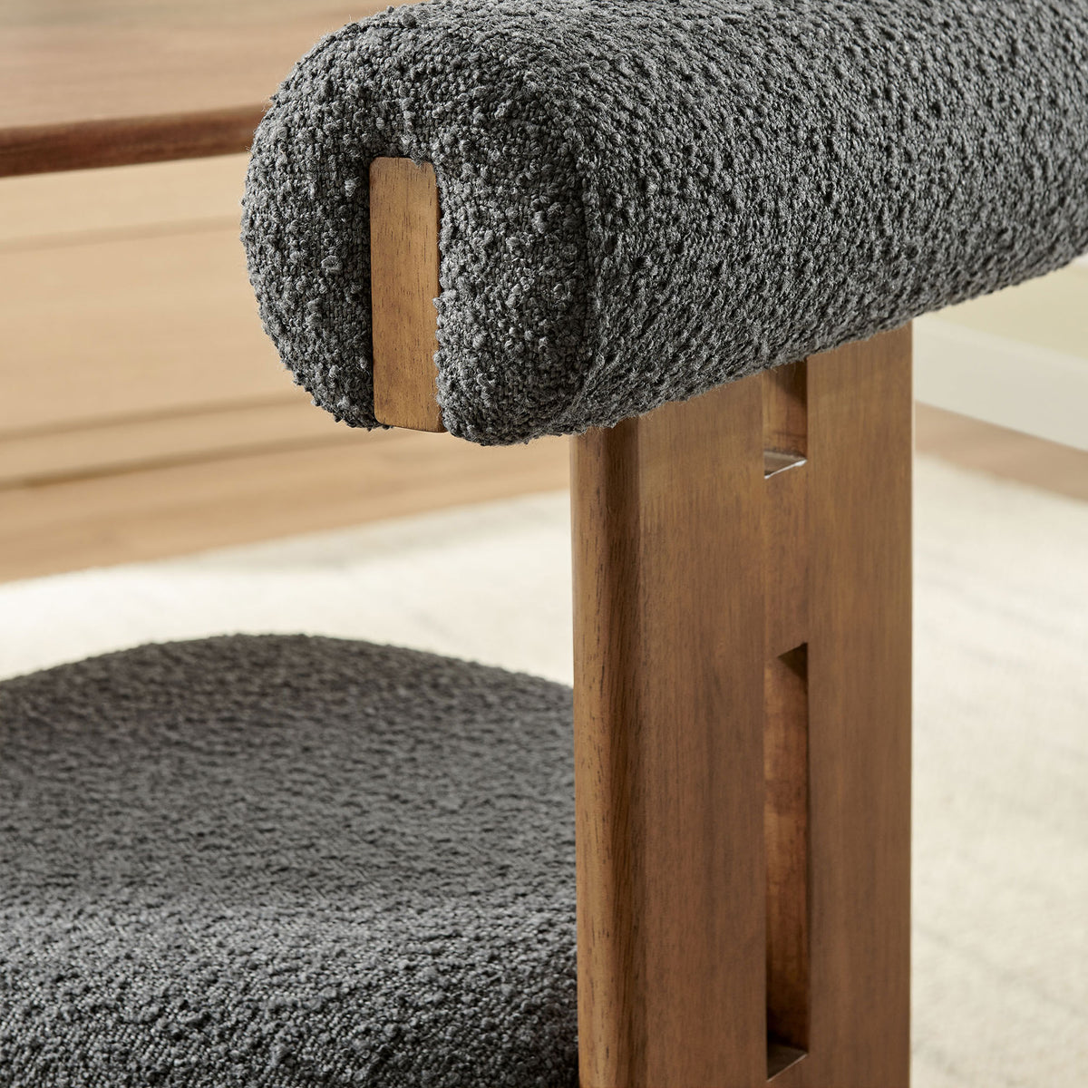 Warm walnut frame and nubby charcoal boucle upholstery create a cozy, modern accent in the dining space || EEI-6960-WAL-CHA || detail_room