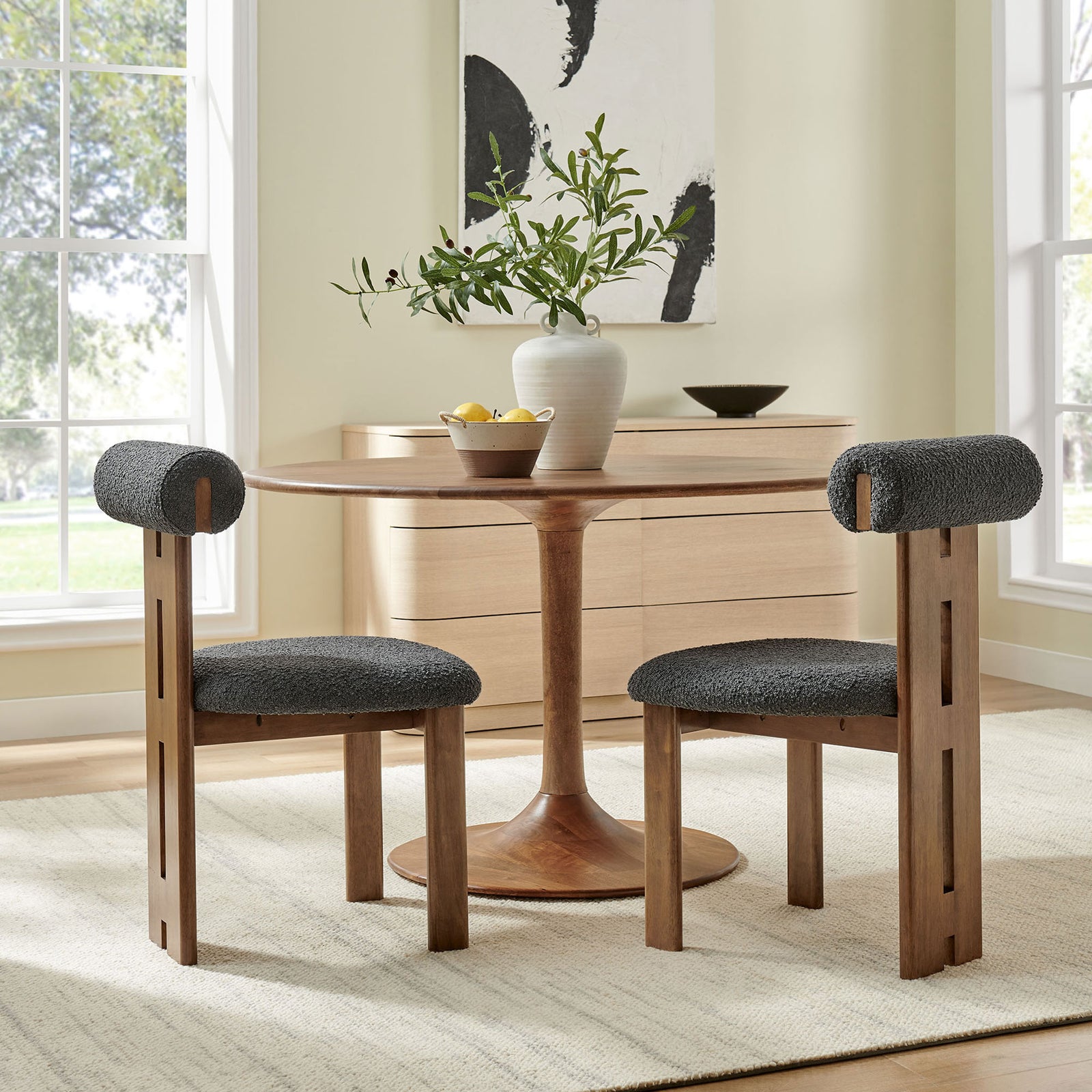 Pair of Torian boucle dining chairs around a round wood table bring retro modern warmth to a bright dining room || EEI-6960-WAL-CHA || back_angle_multi_room