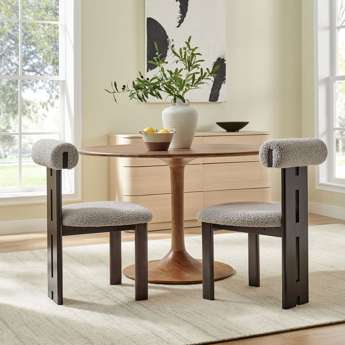 Modern dining nook with two taupe boucle chairs and wenge frames surrounding a warm wood pedestal table. || EEI-6960-WEN-TAU || front_angle_multi_room