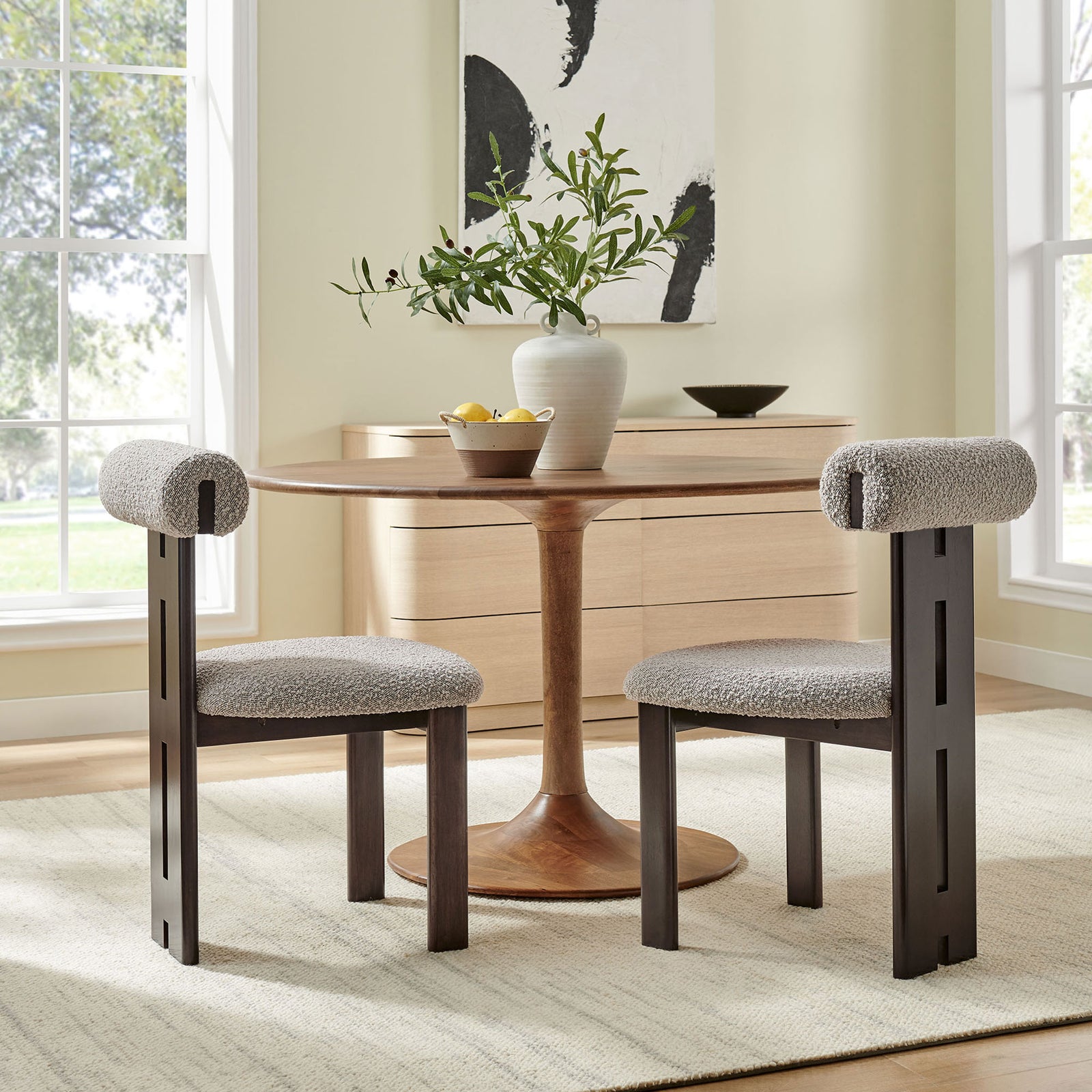 Modern dining nook with two taupe boucle chairs and wenge frames surrounding a warm wood pedestal table. || EEI-6960-WEN-TAU || front_angle_multi_room