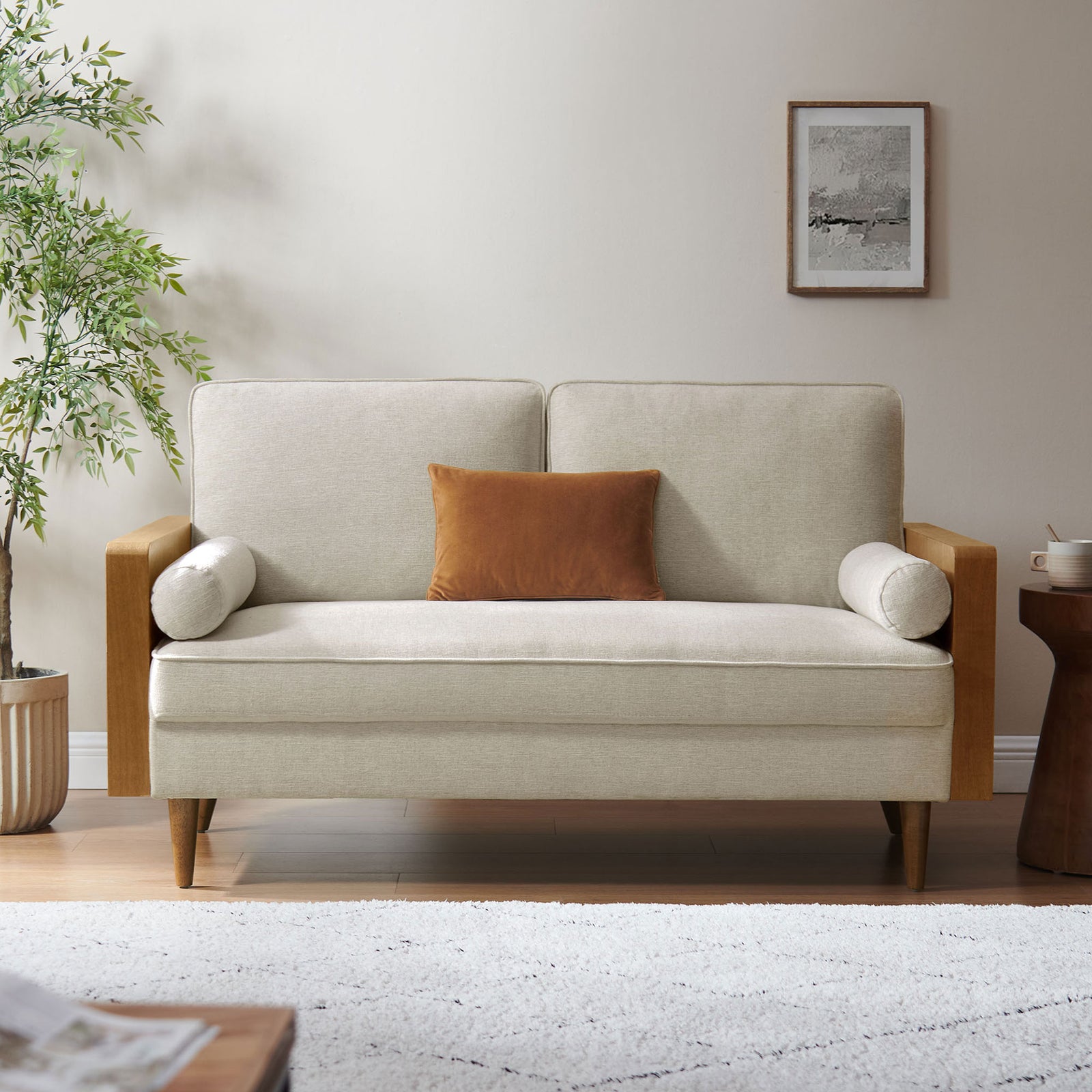 Kellan loveseat in a cozy living room, styled with an accent pillow, rug, and wood side table || EEI-6962-WAL-HLB || front_room