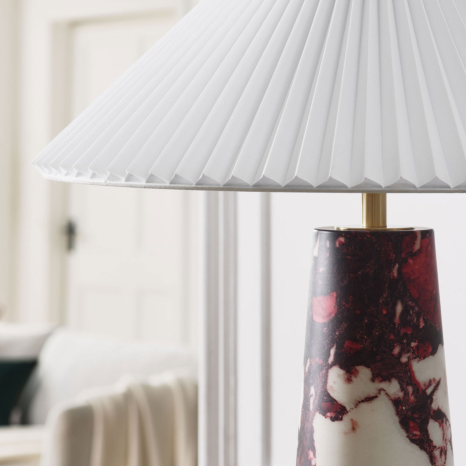 Nera red marble table lamp bringing a warm accent to a soft, neutral living room. || EEI-6963-RED || detail_room