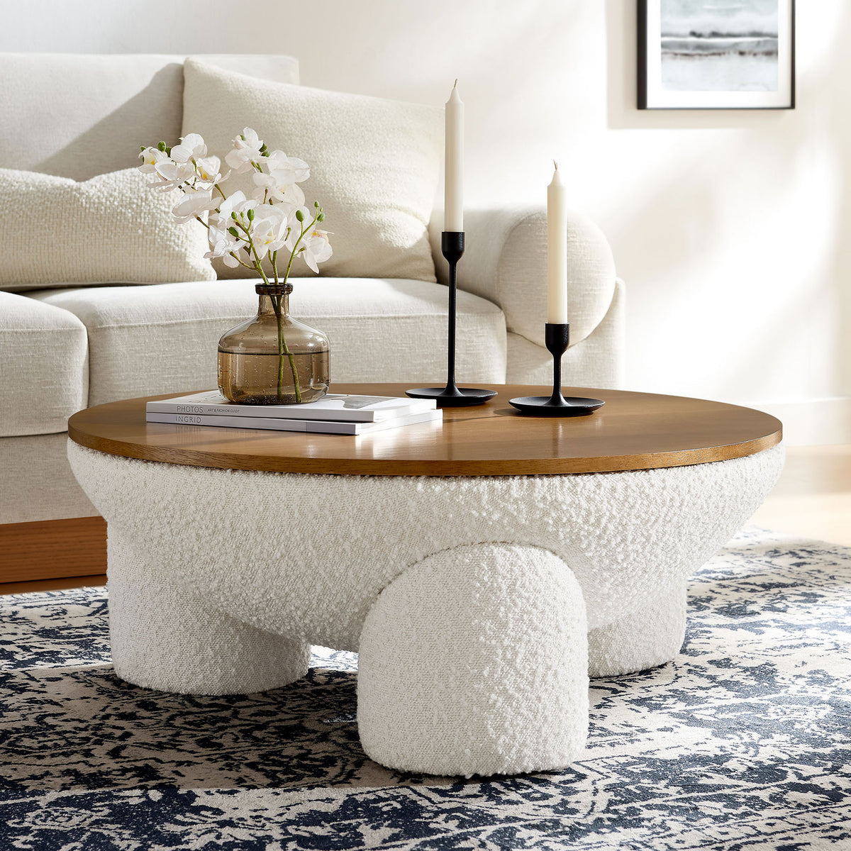 Modern round coffee table anchors the room with boucle texture and a smooth wood surface || EEI-6964-NAT-IVO || front_angle_room