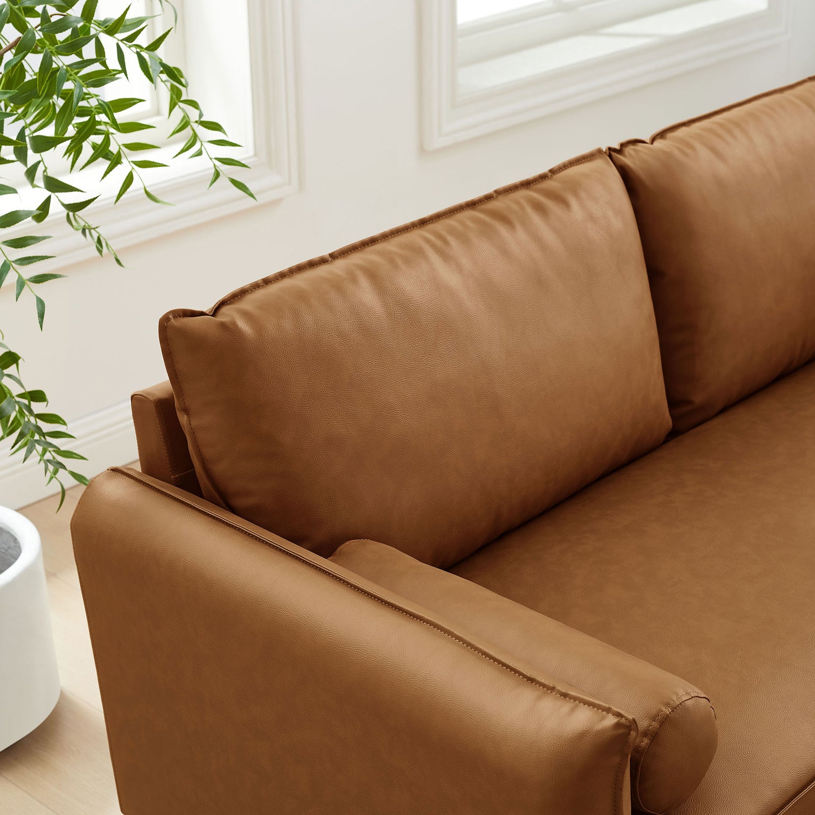 Plush back cushions and wide seat in tan vegan leather for relaxed lounging || EEI-6975-TAN || detail_room