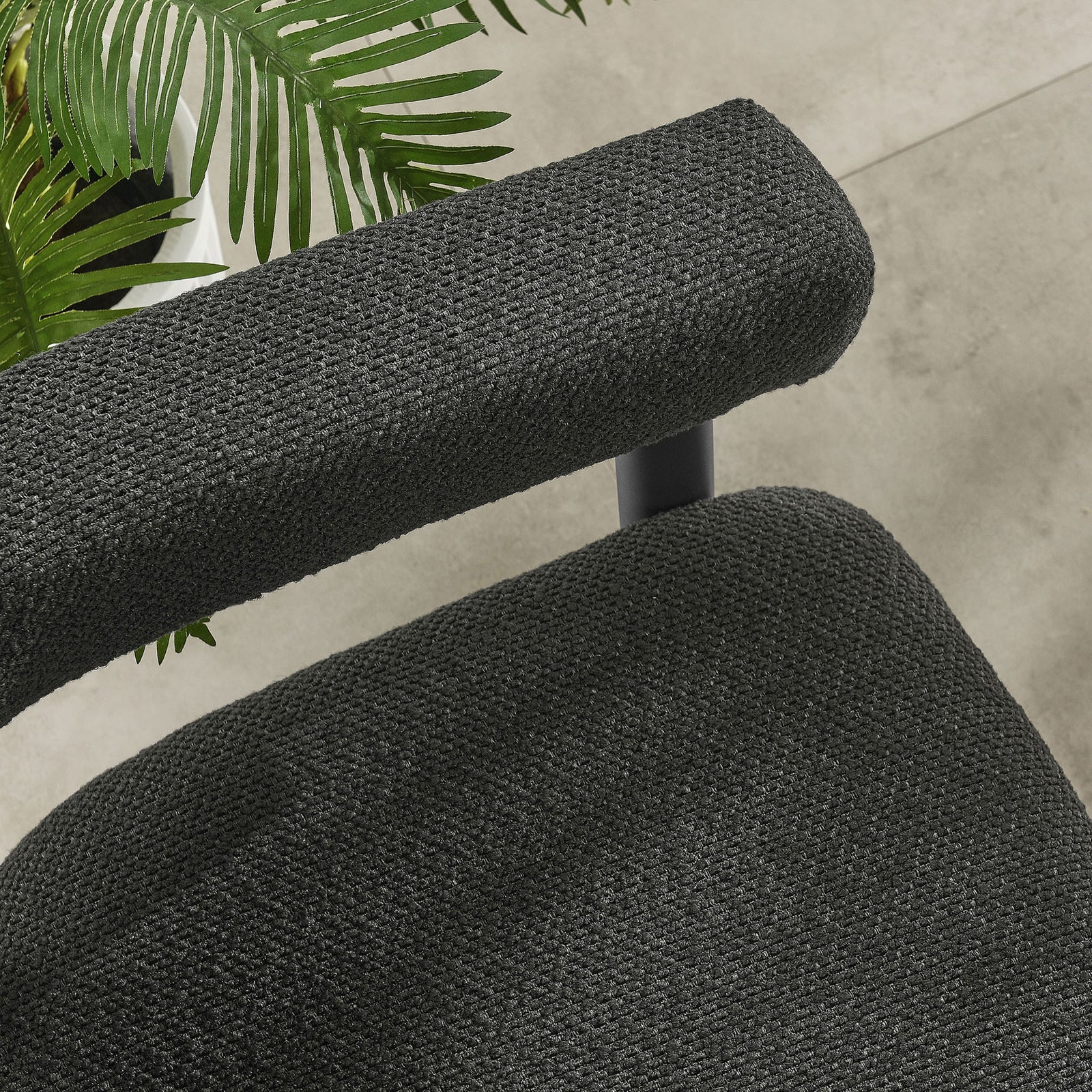 Charcoal graphite seat and armrest upholstery paired with a black metal frame on a contemporary patio floor || EEI-6979-CHA-GPH || detail_room