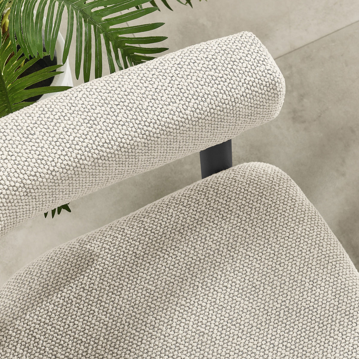 Ivory seat and armrest cushions contrasted against a dark metal frame on a smooth tiled patio floor || EEI-6979-IVO-GPH || detail_room