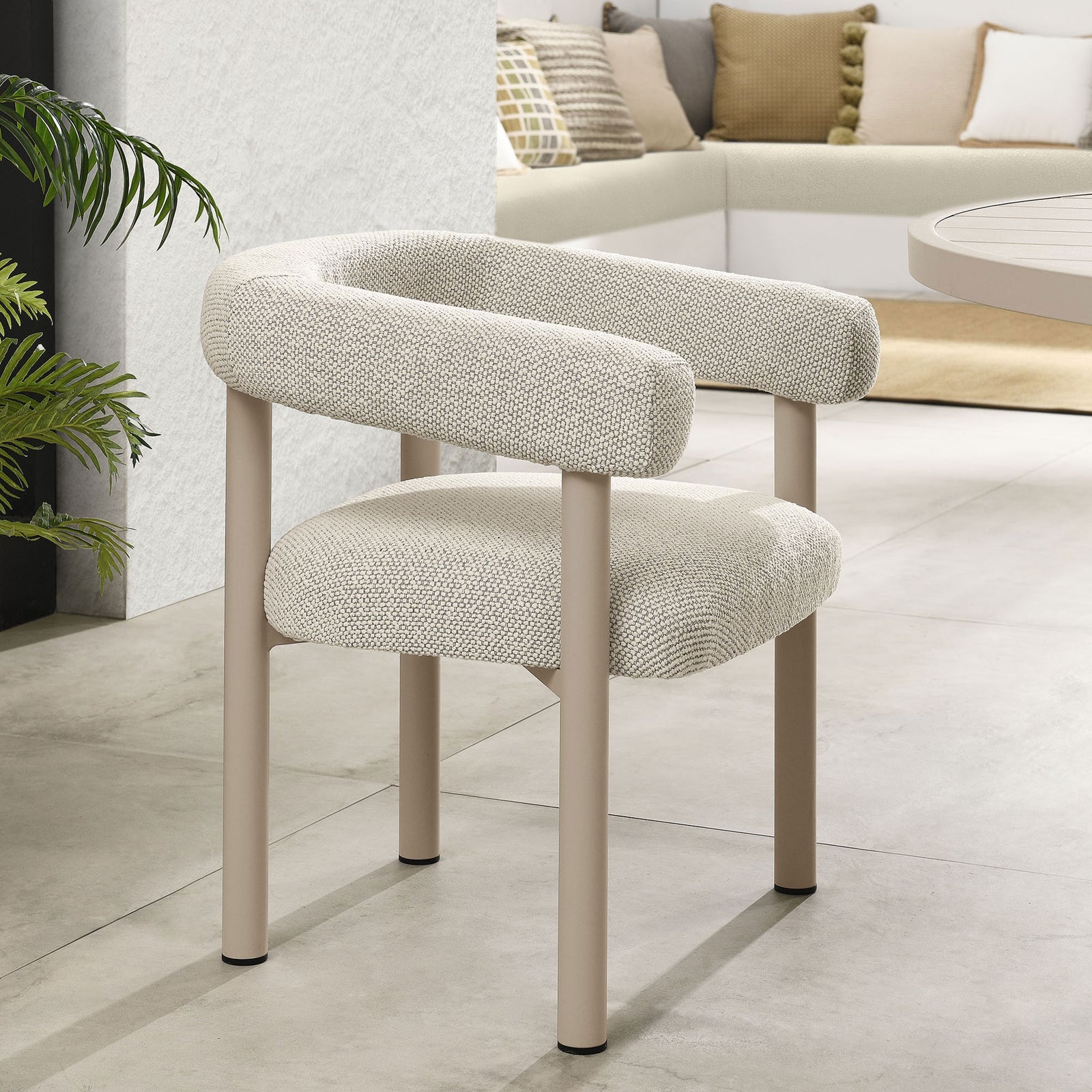 Ivory upholstered patio dining chair paired with a taupe table in a bright, minimalist outdoor lounge || EEI-6979-IVO-TAU || front_angle_room