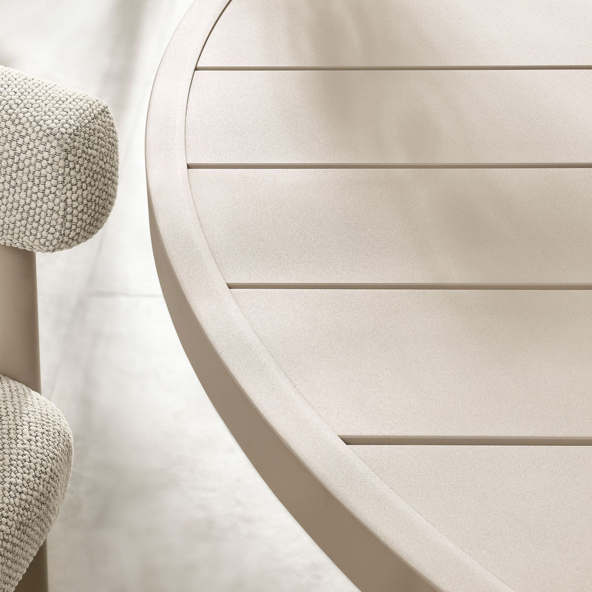 Taupe slatted round tabletop with subtle matte finish, styled with greenery above pale stone tile flooring || EEI-6981-TAU || detail_room