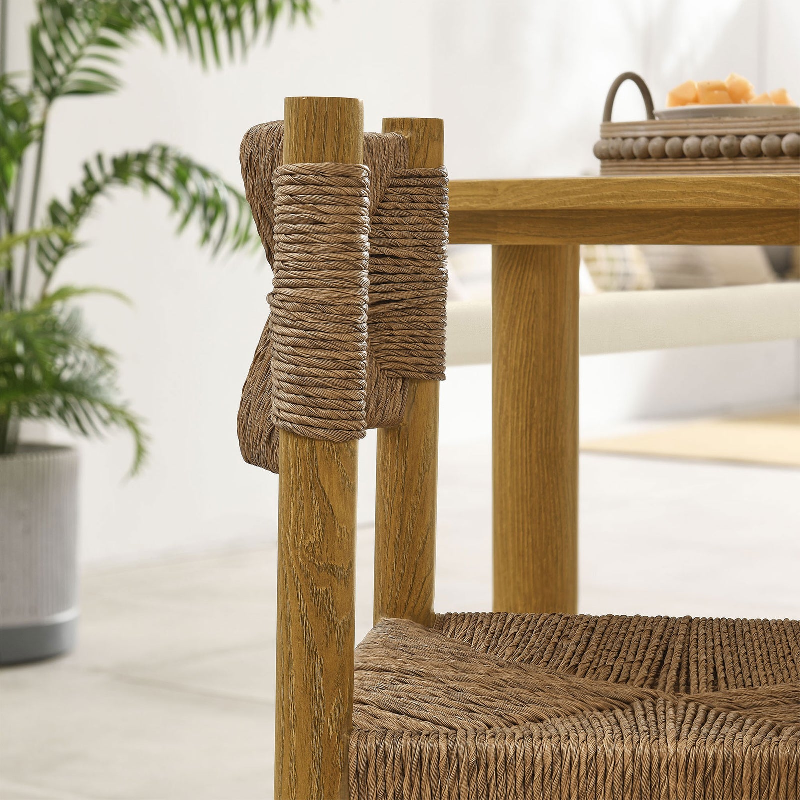 Natural rattan wrapping neatly around the chair posts beside the dining table for a warm, crafted look || EEI-6982-NAT || detail_room