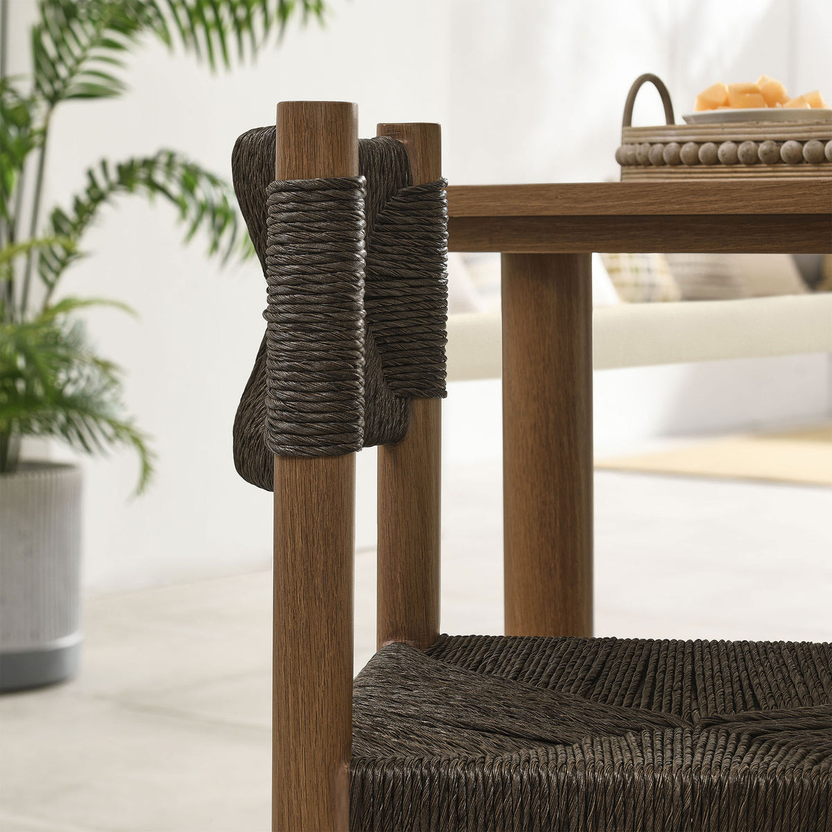 Dark rattan wraps neatly around the chair posts beside the table, adding crafted texture to the setting || EEI-6982-WAL || detail_room