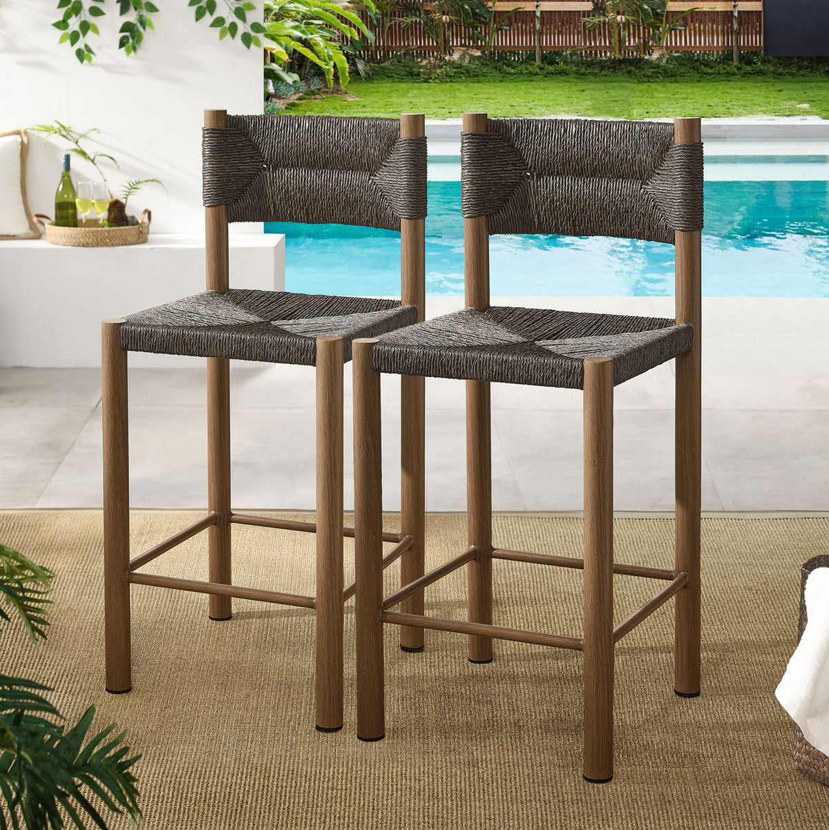 Pair of walnut counter stools completes an inviting outdoor dining and entertaining space || EEI-6983-WAL || front_angle_multi_room