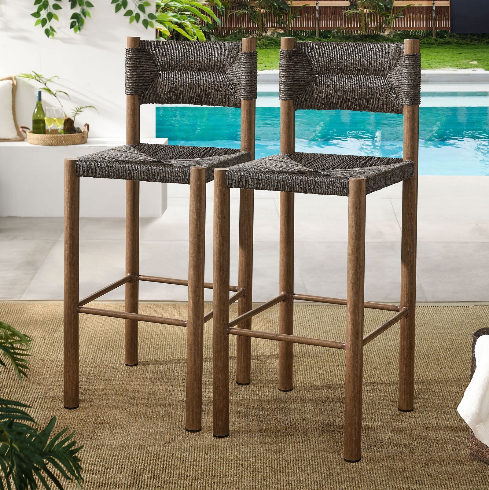 Pair of walnut bar stools creates a polished outdoor bar scene with woven warmth || EEI-6984-WAL || front_angle_multi_room