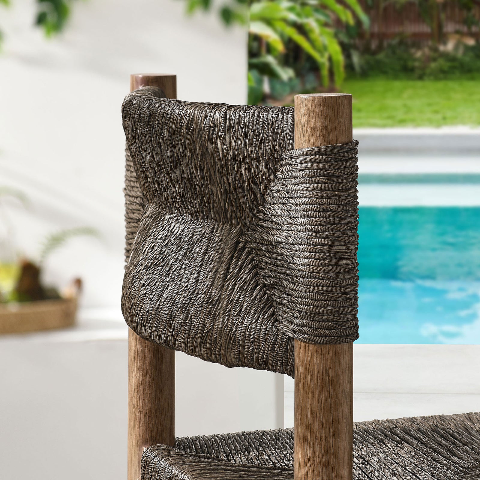 Woven backrest in deep rattan tones softens the clean lines of the poolside setting || EEI-6984-WAL || swatch_room