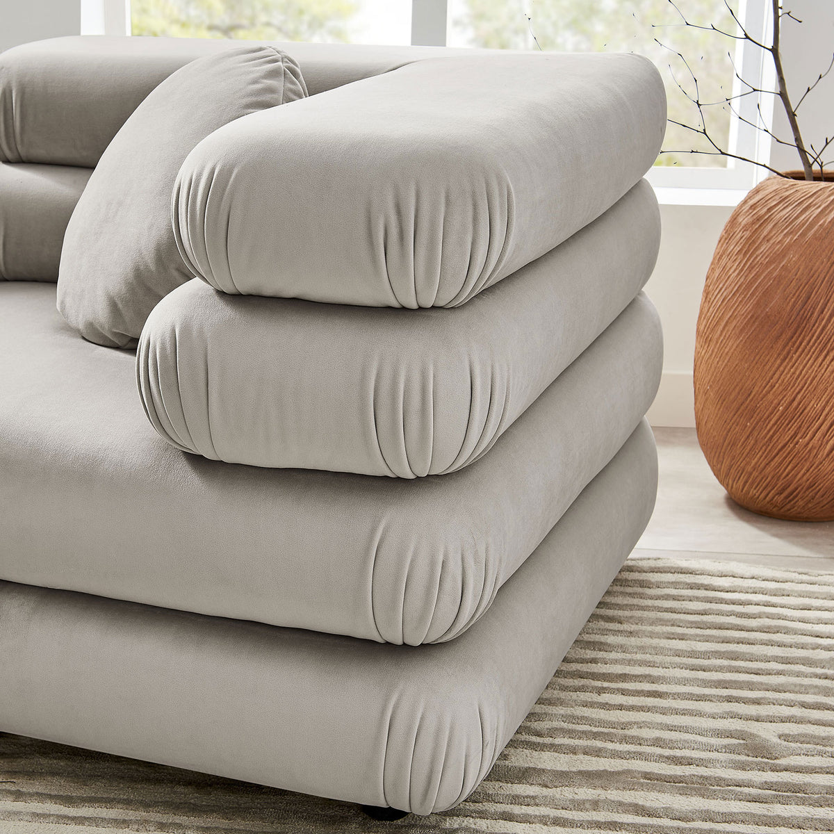 Rounded layered cushions showcase the plush texture of the almond performance velvet upholstery || EEI-7003-ALM || detail_room