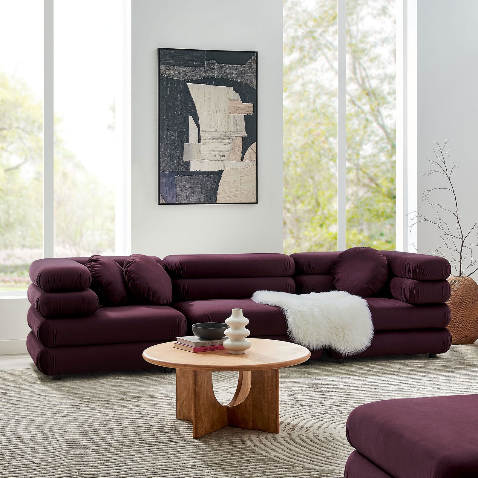 Mulberry velvet modular sectional arranged in an inviting corner layout with layered cushions and soft round pillows || EEI-7003-MUL || front_angle_room