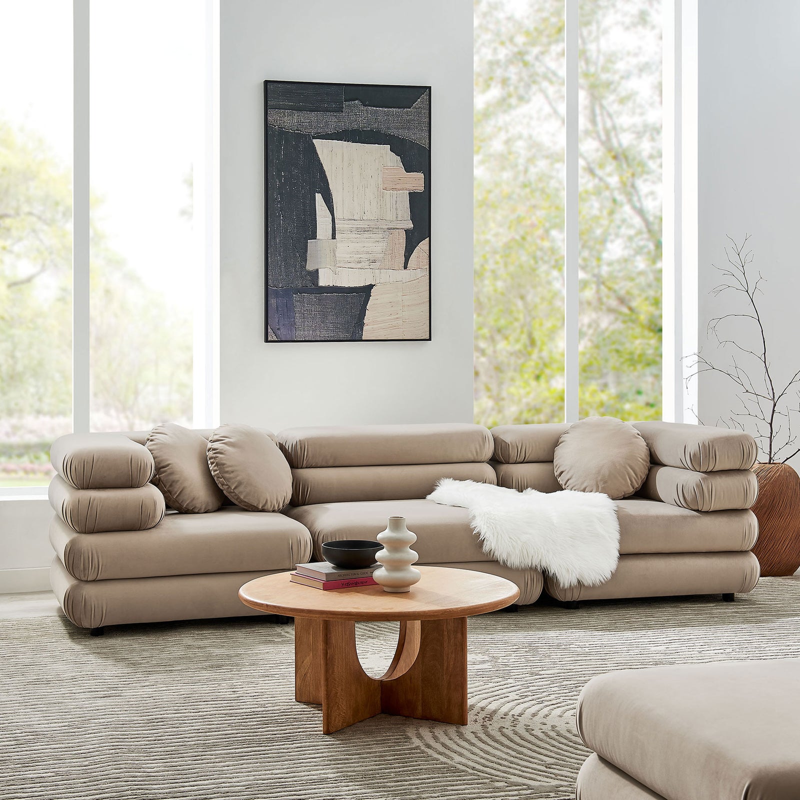 Taupe Jubilee modular sectional styled in a bright living room with soft rug, wall art, and round accent pillows || EEI-7003-TAU || front_angle_room