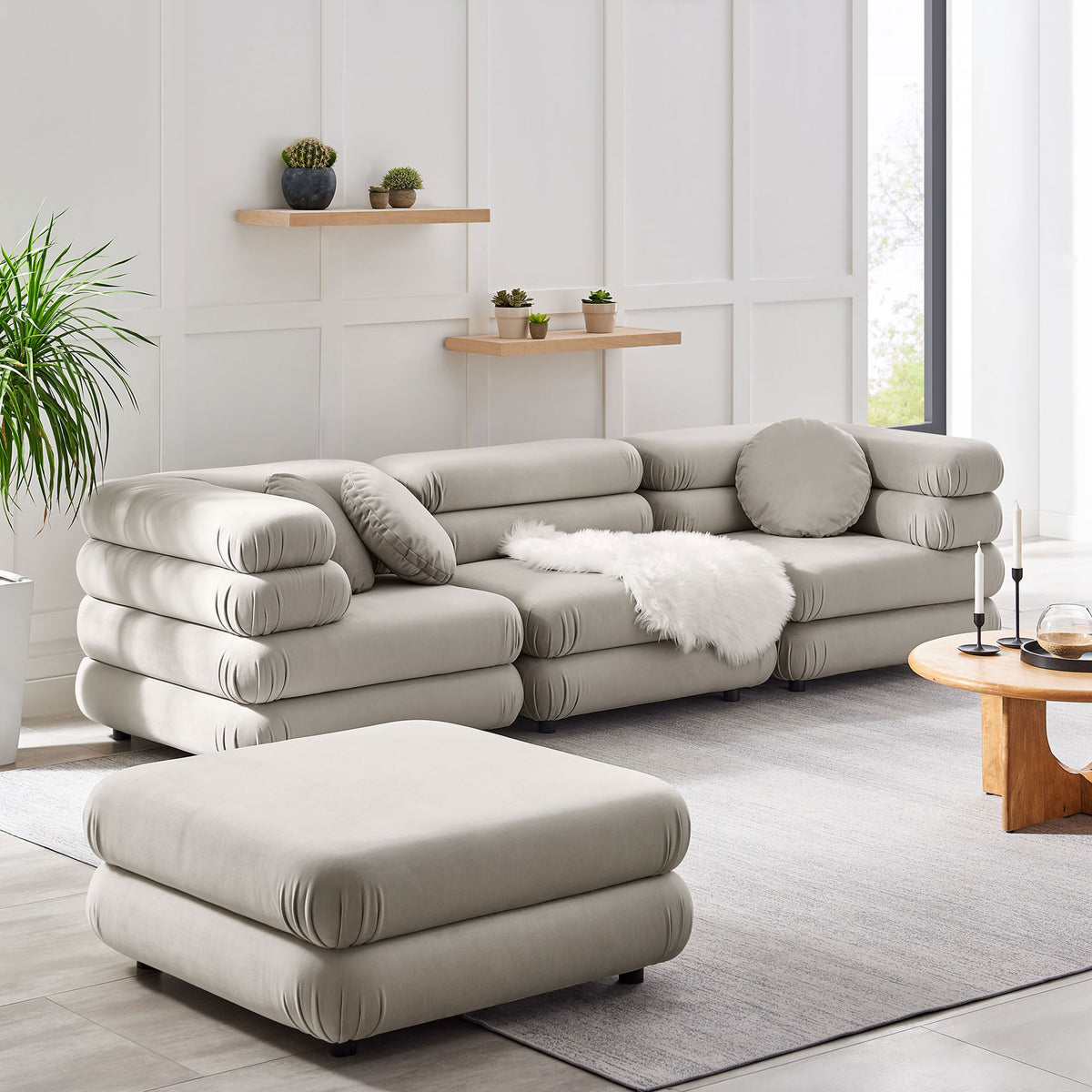Spacious almond modular sectional with ottoman, layered cushions, and cozy textures in a contemporary living space || EEI-7004-ALM || front_angle_room