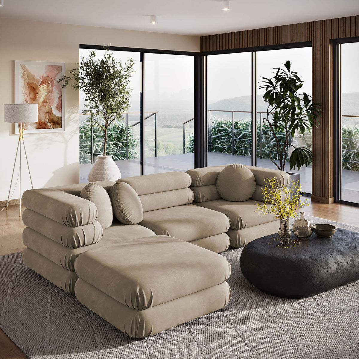 Spacious taupe velvet sectional with ottoman in a modern living room with large windows || EEI-7004-TAU || front_angle_room