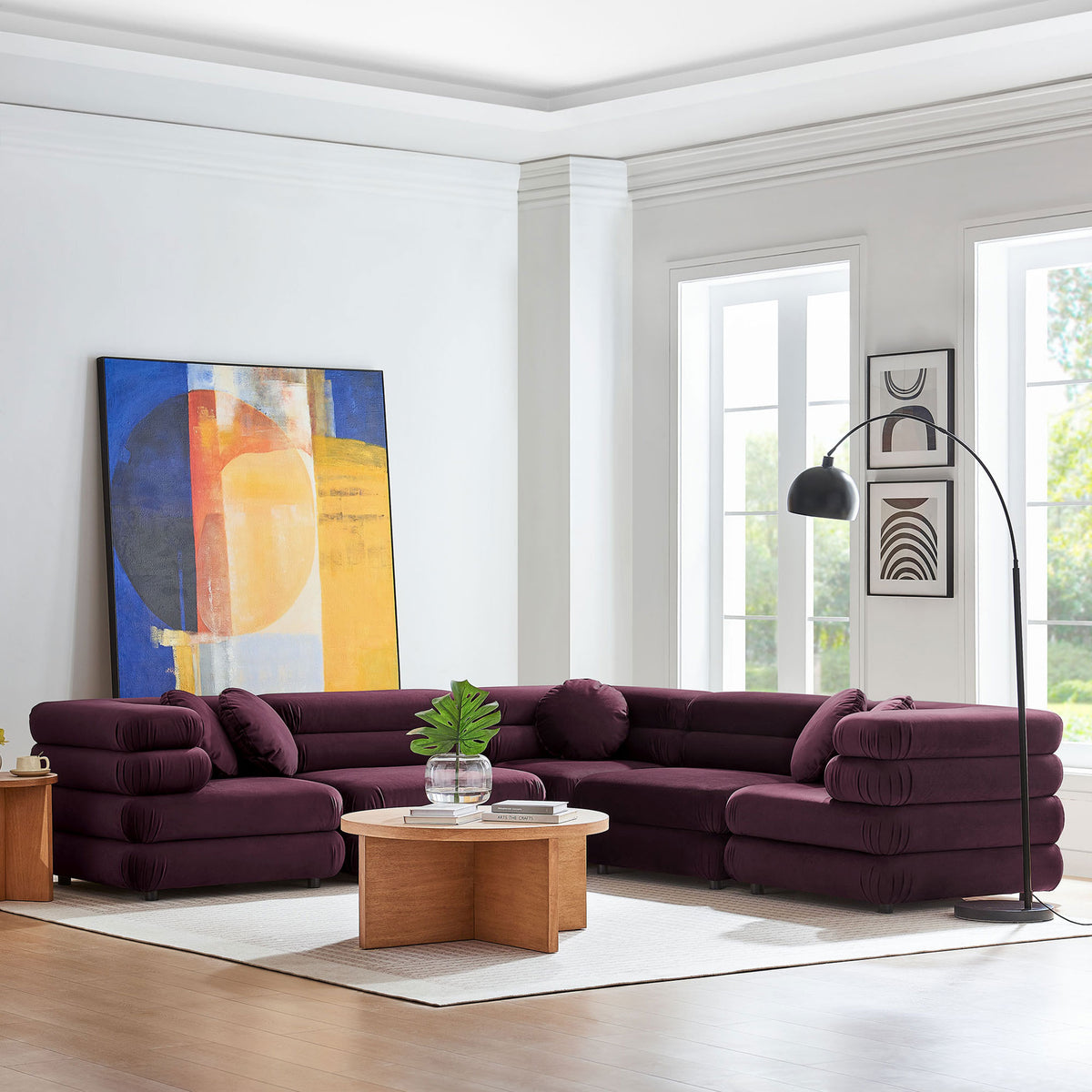 Mulberry velvet L-shaped sectional styled in a bright living room with round wood coffee table and floor lamp || EEI-7005-MUL || front_angle_room
