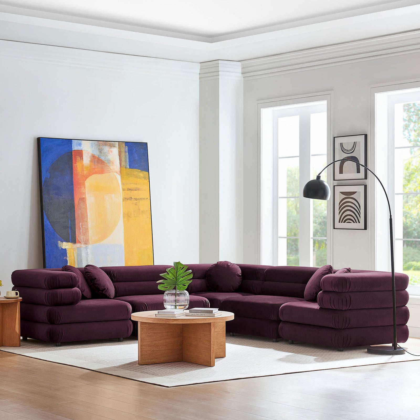 Mulberry velvet L-shaped sectional styled in a bright living room with round wood coffee table and floor lamp || EEI-7005-MUL || front_angle_room